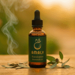 Premium eucalyptus essential oil blend in a luxury amber dropper bottle displayed beside fresh silver dollar eucalyptus leaves
